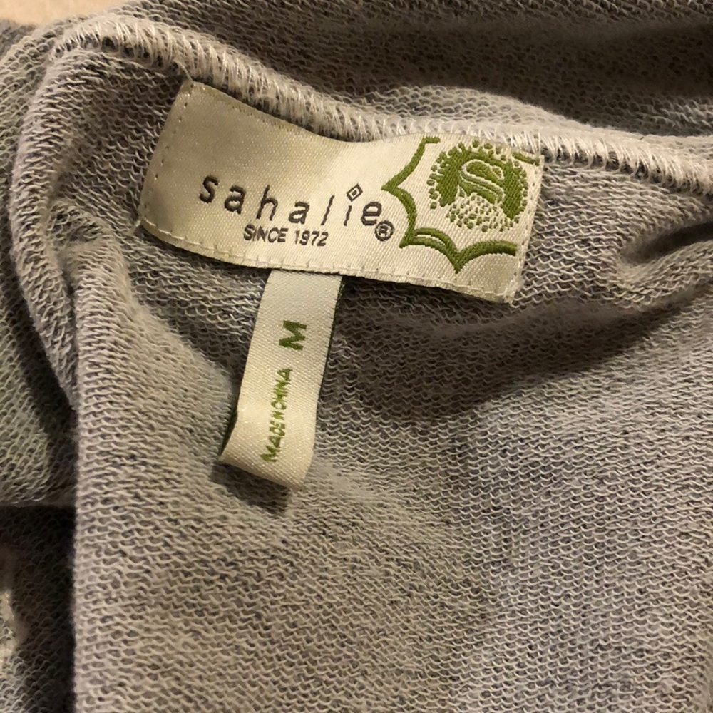 The belted cost is size medium but the matching skirt and pants are size large